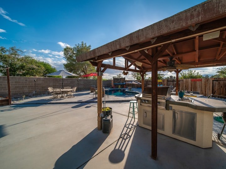 A timber pergola over an outdoor patio.