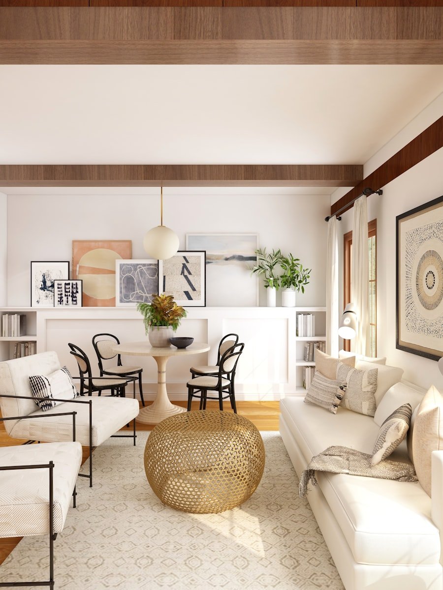 An open living and dining room with exposed ceiling beams and fitted joinery.