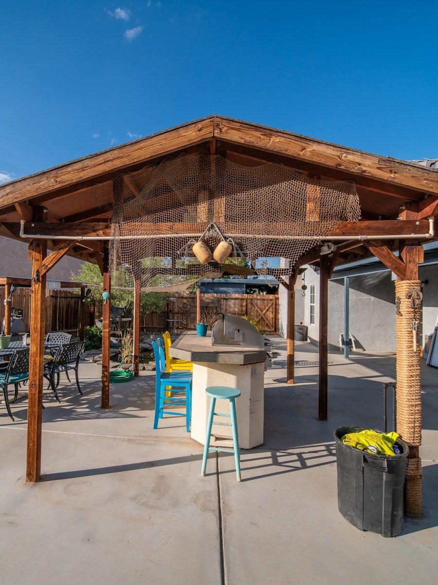 A timber pergola over a paved patio.